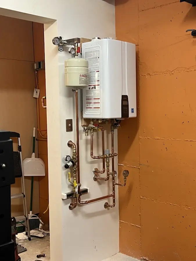 Plumbing technician inspecting water heater connections in Zephyrhills West